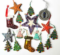 a group of christmas ornaments hanging from strings