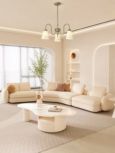 a living room with white furniture and large windows