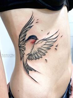 a woman's stomach with a bird tattoo on her side and the bottom part of her body