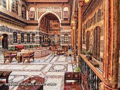 an ornately decorated lobby with chandeliers and tables