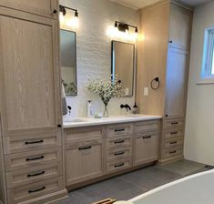 a large bathroom with wooden cabinets and white bathtub