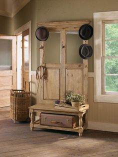 a wooden bench sitting in front of a mirror on top of a hard wood floor