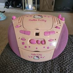 a hello kitty speaker sitting on top of a carpet