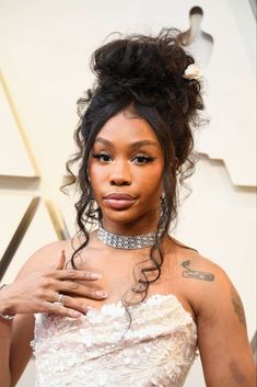 an image of a woman with tattoos on her chest wearing a strapless white dress