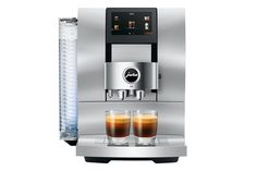 an espresso machine with two glasses on the side