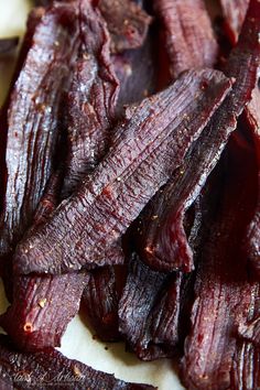 closeup of sliced red beets sitting on top of a cutting board with seasoning