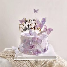 a birthday cake with purple butterflies on it