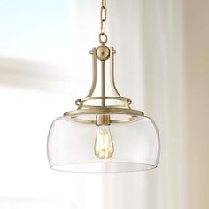 a light fixture hanging from the ceiling with a clear glass dome on it's end