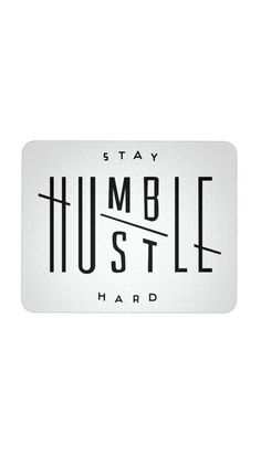 a cup of coffee sitting on top of a table next to a sign that says, stay humble hustle hard