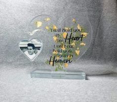 a heart shaped glass plaque with flowers in the center and a quote on it that says, i will hold you my heart