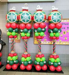 christmas decorations are displayed in front of a bulletin board