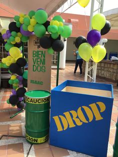 some balloons are hanging from the ceiling and in front of a propaner box