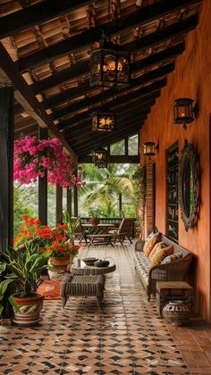 an outdoor covered porch with potted plants and flowers