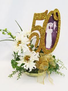 a 50th birthday bouquet with flowers and a photo