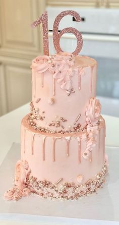 a pink birthday cake with the number sixteen on top