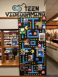 a video game themed bulletin board in the middle of a library with stickers on it