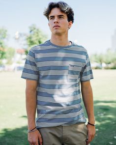 Featuring a yarn-dyed stripe pattern, a left chest pocket, and a bias self-fabric neck tape, this blue short sleeve shirt offers a timeless look. Pair it with your favorite denim for a casual-cool vibe that's perfect for any occasion. YARN DYE STRIPE YARN DYE STRIPE Left chest pocket Bias self fabric neck tape Woven label Snow Surfing, Blue Short Sleeve Shirt, Waverly Place, Woven Label, Woven Labels, Shopping Spree, Blue Shirt, Blue Shorts, Yarn Dyeing