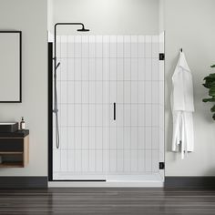 a bathroom with a shower, sink and towel rack in front of the mirror on the wall