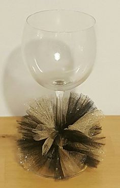 a wine glass sitting on top of a wooden table