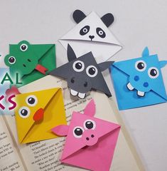 some origami animals are on top of an open book