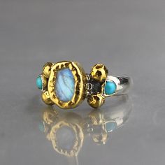 Moonstone Wedding Ring, Gold Moonstone Ring, Silver and Gold Ring, Mixed Metal Ring, Multistone Ring Turquoise Multi-stone Round Opal Ring, Unique Turquoise Opal Ring With Multi-stone Design, Unique Turquoise Multi-stone Opal Ring, Unique Gold Turquoise Ring For Wedding, Artisan Turquoise Opal Ring, Unique Turquoise Gemstone Ring For Wedding, Spiritual Moonstone Wedding Ring With Natural Stones, Bohemian Multi-stone Wedding Rings, Fusion Style Moonstone Gemstone Ring For Anniversary