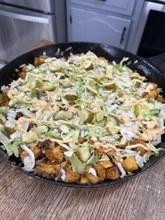 a pan filled with food sitting on top of a wooden table