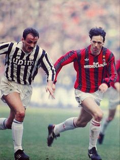 two soccer players running after the ball during a game