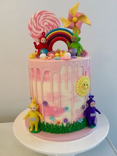 a pink cake decorated with candy and candies