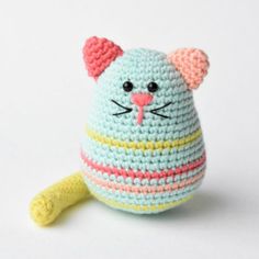 a small crocheted cat toy sitting on top of a white surface