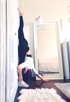 a person is doing a handstand on the floor