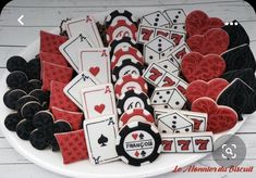 cookies decorated with playing cards and hearts on a plate