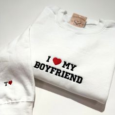 Show your love in style with our "I love my Boyfriend" embroidered sweatshirt! Available in both crewneck and hoodie styles, this cute design is perfect for matching outfits with your significant other. Add your initials to the sleeve for a personal touch. Don't forget to check out our "I love my Girlfriend" version too! This makes the perfect gift for any couple. *Please keep in mind that embroidered designs cannot be resized. This design is sized at approx. 6.6 inches wide* I Love My Bf, Boyfriend Sweatshirt, Love My Girlfriend, Custom Crewneck, I Love My Boyfriend, Embroidered Designs, I Love My Girlfriend, Love My Boyfriend, Embroidered Sweatshirt