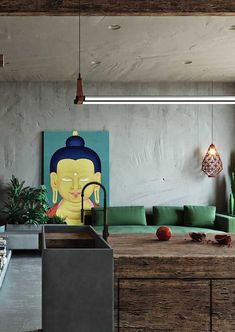 a kitchen with a sink, green couch and painting on the wall above it's counter