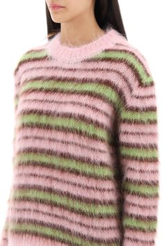 a woman wearing a pink and green striped sweater