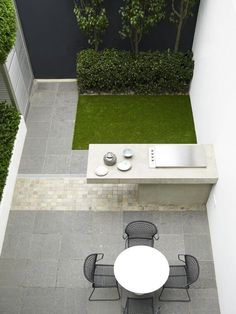 an aerial view of a small backyard with table and chairs