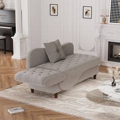 a living room with a couch, coffee table and piano in the corner by the fireplace