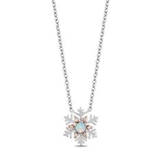 Indulge in the enchanting beauty of ice and snow with our Elsa inspired necklace, a dazzling piece that echoes the elegance of the beloved Ice Queen. Crafted in sterling silver and adorned with 10K rose gold accents, this necklace features a stunning snowflake design with a created opal in the center. The intricately designed snowflake captures the essence of Elsa's magical powers, evoking the shimmering beauty of ice crystals. 2 Carat Ring, Enchanted Disney, Enchanted Disney Fine Jewelry, Disney Fine Jewelry, Tiara Ring, Rose Gold Accents, Snowflake Design, Inspired Necklace, Right Hand Rings