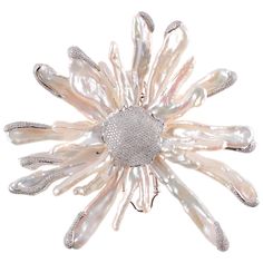 A striking 18 Karat White Gold Flower Brooch by Yvel of Israel with Keshi Pearls and set with 5.72 carats of diamonds. The pearls have a white body color, excellent to moderate luster, and range from approximately 20 mm to 50 mm in length. The brooch is pave' set with over a thousand diamonds weighing approximately 5.70 carats. VS clarity G -H in color. Weight of brooch is 70.4 grams. One pearl is missing. Current Retail Replacement Value is $50,000. Luxury Handmade White Brooches, Luxury White Diamond Brooch, Formal White Pearl Brooches, White Pearl Brooches For Formal Occasions, Diamond Flower Brooch, Long Stem Flowers, Turtle Brooch, Rings Luxury, Golden South Sea Pearls