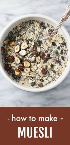 a bowl filled with oats and nuts on top of a table