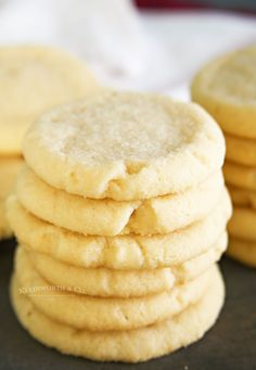 a stack of white cookies sitting on top of a black table next to each other