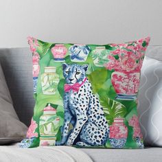 a leopard sitting on top of a couch surrounded by flowers and vases throw pillow