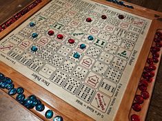 a wooden board game with dices and numbers on it