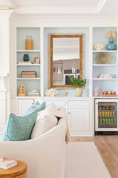 a living room filled with furniture and lots of shelves