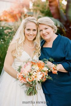 two women standing next to each other holding bouquets