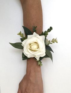 a person's hand with a white flower on it