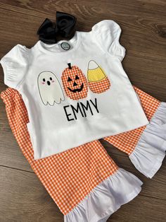 Halloween Trio Monogram Shirt and Matching Pants Check out this adorable halloween outfit for your little one! They will look so cute in this matching handmade outfit this spooky season.  The shirt is 100% cotton and super soft. I embroider it on a professional embroidery machine. The matching pants are handmade by me. I use the same fabric as the embroidery on the shirt. The pants are made with a stretchy elastic, so that the waistband is comfortable for your little one.  You will have the option to add on the handmade, black bow. I attach the bow on an alligator clip, unless your little one is 18 months or younger. If you order a size that is 18 months or smaller, I will attach the bow to a soft, nylon headband.  For the smaller sizes 12 months and 18 months, I have two shirt options. Yo Fall Cotton Sets With Short Sleeves, Cute Long Sleeve Sets For Halloween, Casual Cotton Sets For Halloween, Fitted Playful Sets For Halloween, Playful Fitted Sets For Halloween, Casual Cotton Halloween Sets, Playful Fitted Halloween Sets, Cute Long Sleeve Halloween Sets, Halloween Smocked Outfits