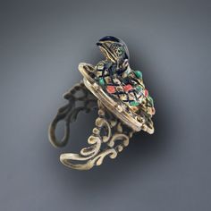 Our snake ring is in the form of a royal serpent with crystal eyes, a neck band of tiny crystal and a body detailed in enamel. Three dimensional, he rests gracefully upon an adjustable, comfortable ring band that fits sizes 6-9. Choice of bronze or silver finish. Shakespeare wrote "Be the innocent flower...be the serpent under it!" Produced in our Los Angeles studio. The snake has been a powerful symbol from the beginning of human history. The serpent goddess Wadjet was an early Egyptian deity. In the Garden of Eden, it is the serpent who creates the drama. The snake's dual symbolism of good and evil has been expressed through all cultures. The very first engagement ring ever presented was to Queen Victoria from Prince Albert. It was a snake, signifying eternal love and wisdom and the betr Serpent Goddess, Serpent Snake, Egyptian Deity, The Garden Of Eden, Crystal Eyes, The Serpent, Crystal Eye, Egyptian Goddess, Human History