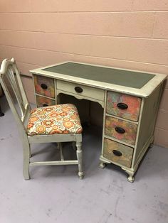 an old desk with a chair next to it