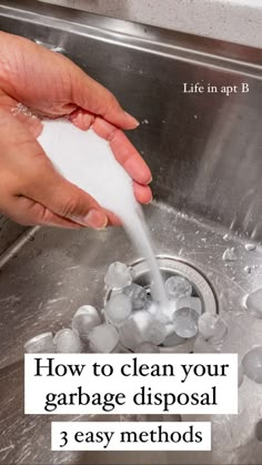 someone is washing their hands in the sink with soap and ice cubes on it