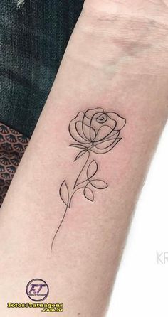 a black and white rose tattoo on the arm